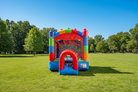 10-foot Commercial Crossover Blocks Bounce House on a grass field with tress in the background - HullaBalloo Sales
