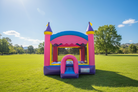 Commercial Crossover 13-foot Princess Bounce House on a grassy field under a clear blue sky - HullaBalloo Sales